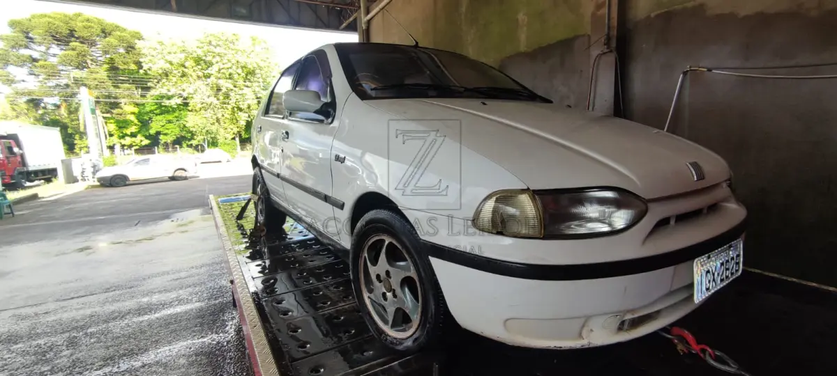 LOTE 006 - Um automóvel da marca FIAT/PALIO, placas IGX2626, ano/modelo 1997/1998, na cor branca, à  gasolina, RENAVAM 687868130.