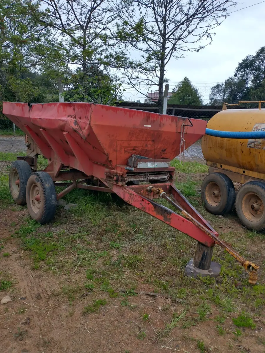 LOTE 006 - Um distribuidor de adubos e calcário esteira.
