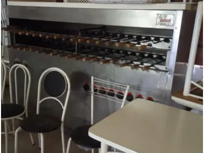 Uma Churrasqueira rotativa a gás Tomasini, 16 queimadores, 35 espetos. Com os espetos.
